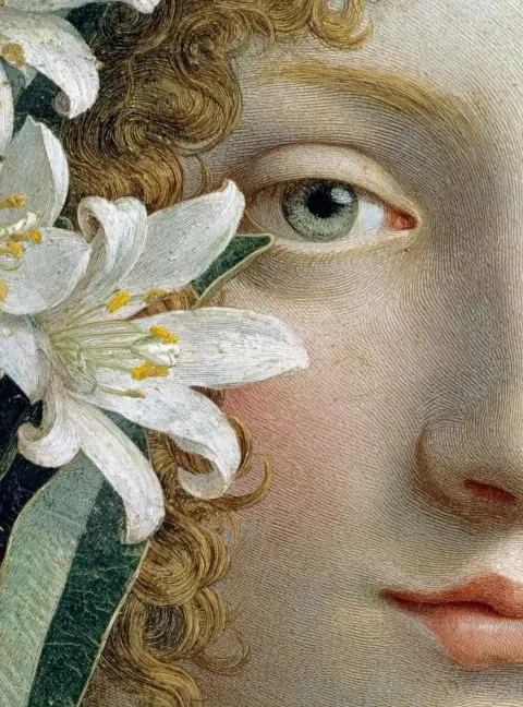 A close-up of a child’s eye framed by white lilies.